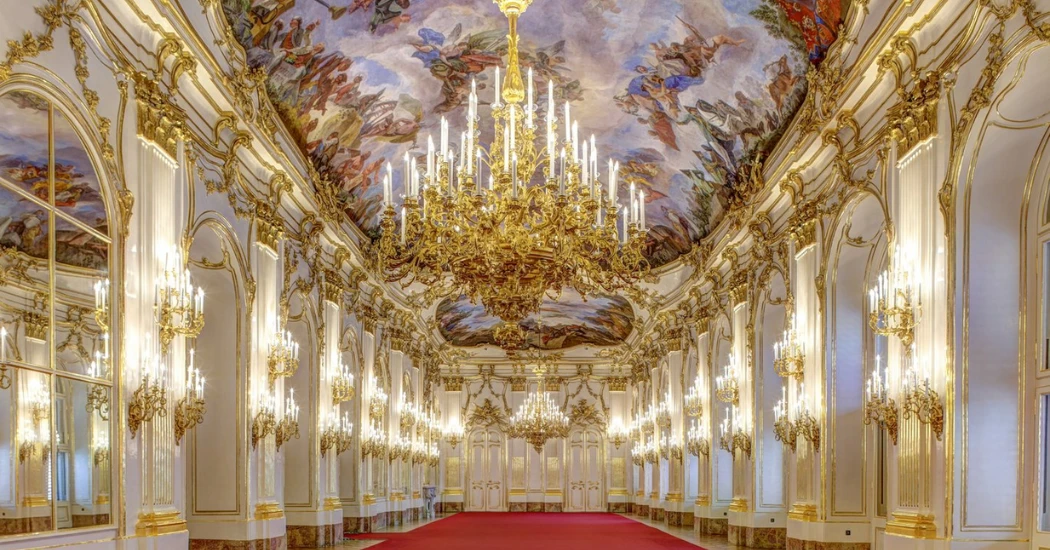 Inside the Great Gallery of Schönbrunn Palace, highlighting grand chandeliers and luxurious decor.