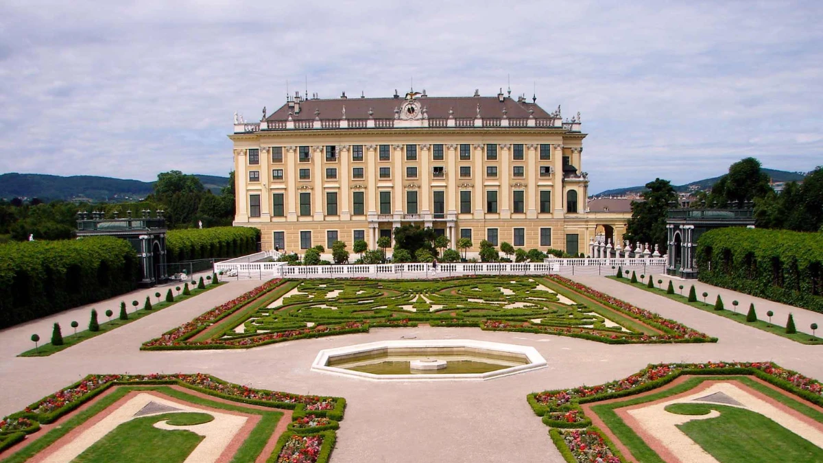 Schönbrunn Palace Vienna surrounded by manicured geometric flower beds and hedges